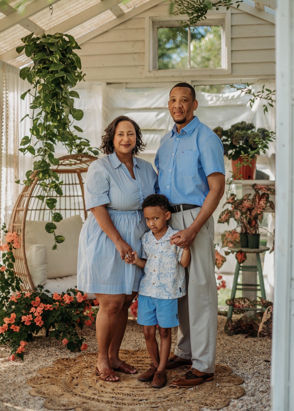Rochelle Campbell in blue with her family in a sunlit garden room